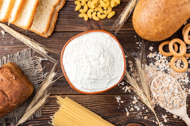 Bakery and pasta products on dark wood.