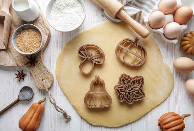 Baking cookies in the form of pumpkin and leaves