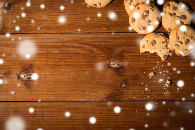 baking, cooking , holidays and food concept - close up of oat cookies on wooden table