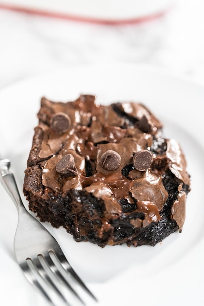 Baking homemade brownies with extra chocolate chips on top.