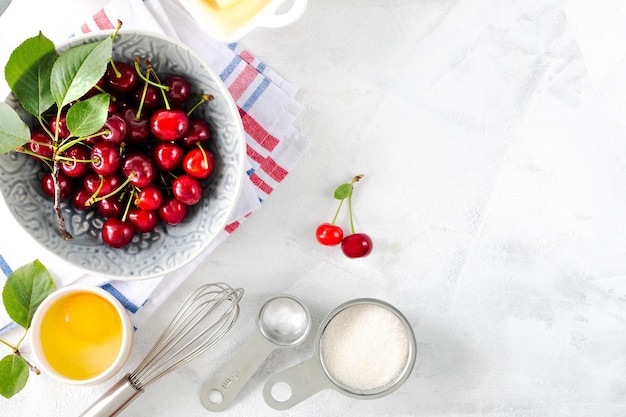 Baking ingredients for a cherry pie copy space Flour eggs cherries milk baking powder and butter