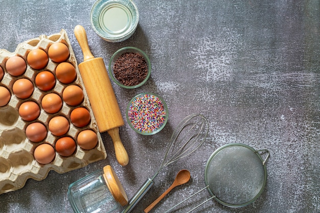 Baking ingredients for making cake pastry or sweet bread on textured blue background