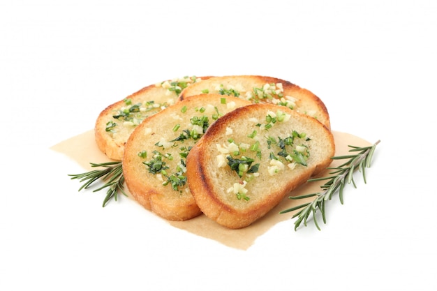 Baking paper with toasted garlic bread slices isolated on white