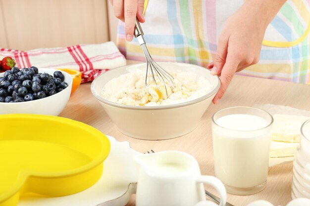 Baking tasty pie and ingredients for it on table in kitchen