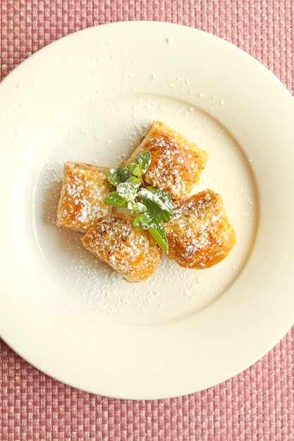 Baklava with walnuts, Turkish delight in a white plate