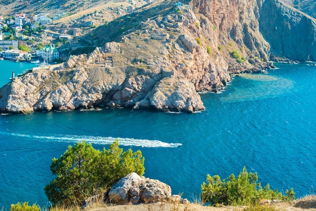 Balaklava bay in summer in sunny weather. Crimea, Russia. A lot of boats and ships. mountains, sea. turquoise water color. Genoese fortress Chembalo