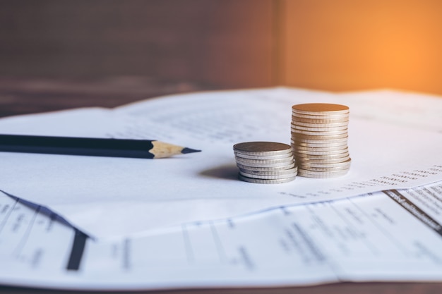 Balance sheet with pencil and coins on bank Statement, Account concept. 