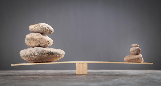 Balance stones on wooden scales.