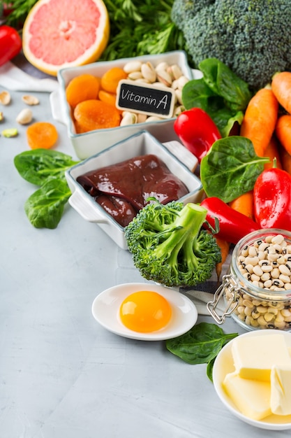 Balanced diet nutrition, healthy clean eating concept. Assortment of food sources rich in vitamin a on a kitchen table. Copy space background