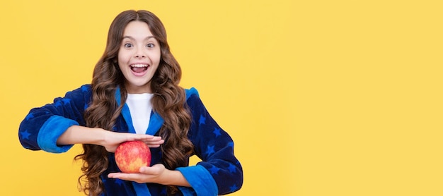 Balanced diet smiling kid having breakfast in homewear childhood healthcare and organic diet Child girl portrait with apple horizontal poster Banner header with copy space