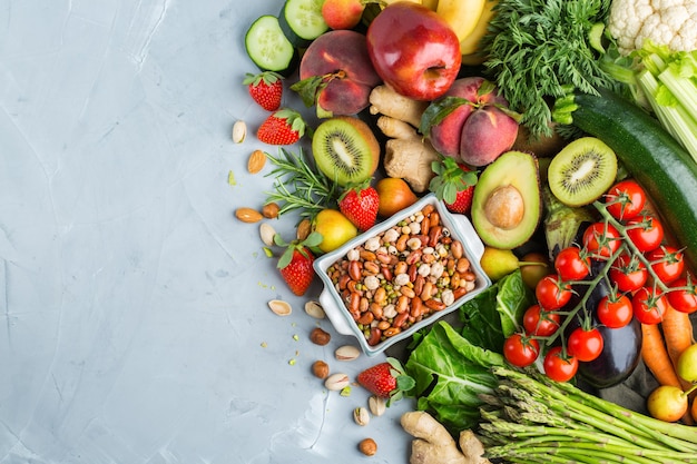 Balanced nutrition concept for clean eating alkaline diet. Assortment of healthy food ingredients for cooking on a kitchen table. Top view flat lay background