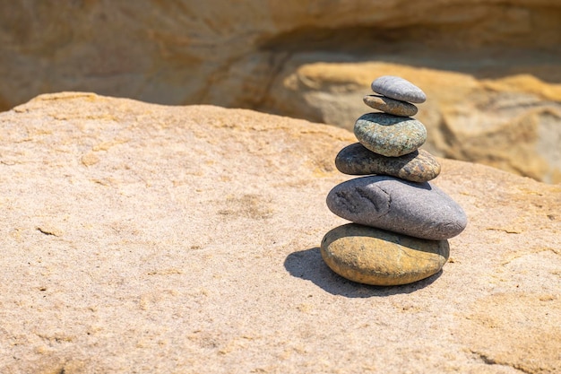 Balanced pebbles pyramid on the beach zen stones