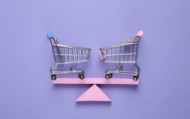 Balancing swing with shopping carts on purple pastel background Minimalism Geometry shapes Creative layout