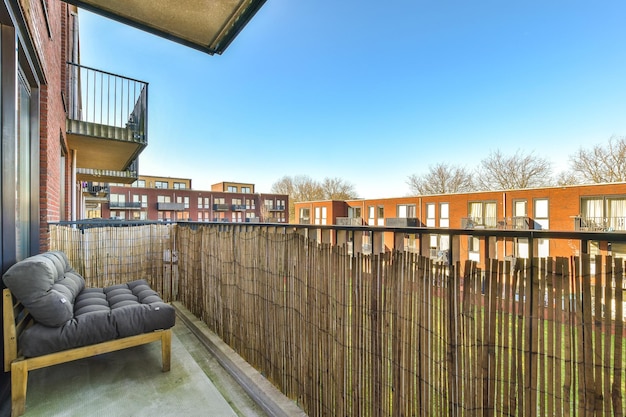 A balcony with a couch and a fence and a