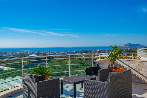 A balcony with a view of the ocean and the sea.