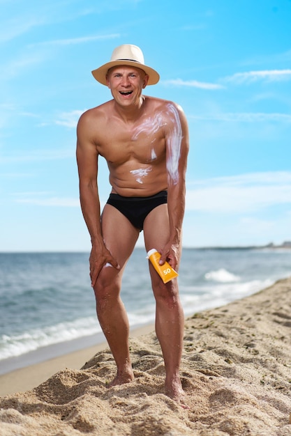 Bald man on the beach by the sea on vacation