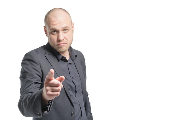 Bald man in a gray suit showing forefinger forward Isolated