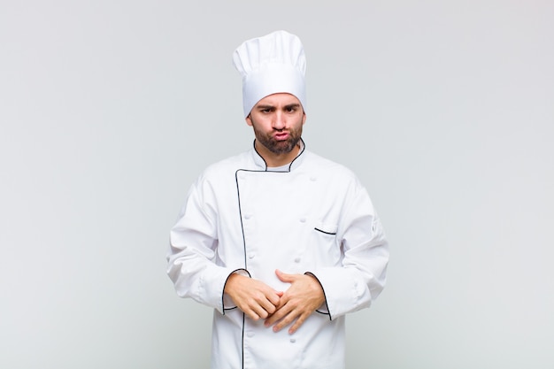 Bald man looking goofy and funny with a silly cross-eyed expression, joking and fooling around