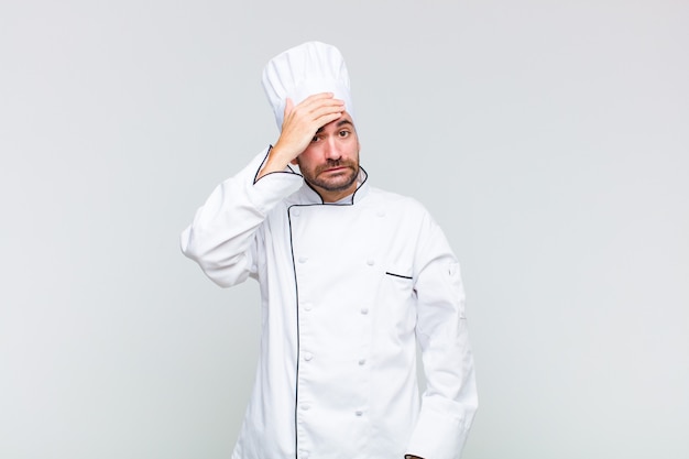 Bald man panicking over a forgotten deadline, feeling stressed, having to cover up a mess or mistake