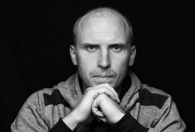 Bald young man looking and portrait in bw