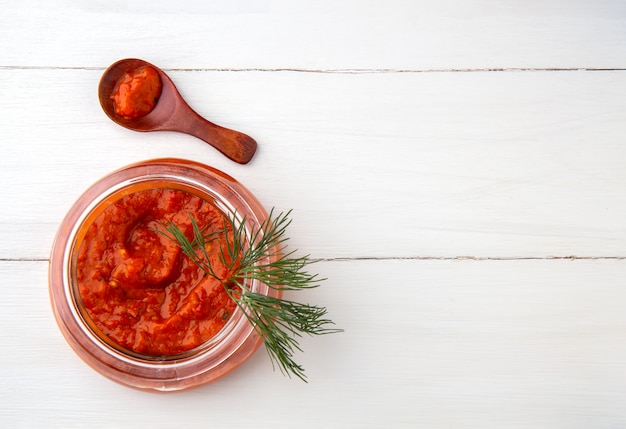 Balkan snack ajvar in a jar on a white space