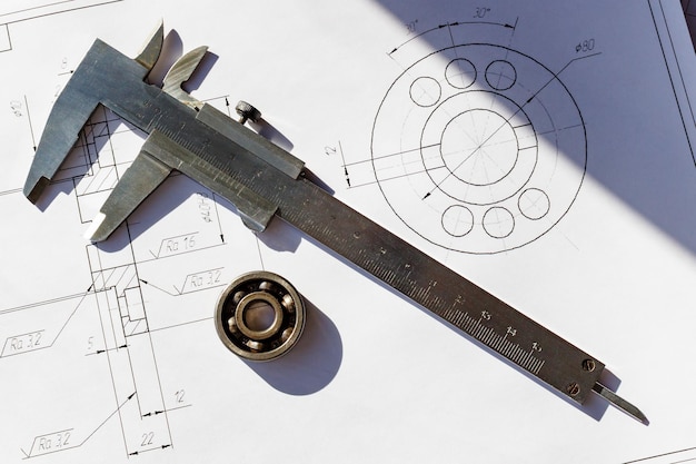 Ball bearing and caliper on the background of drawings