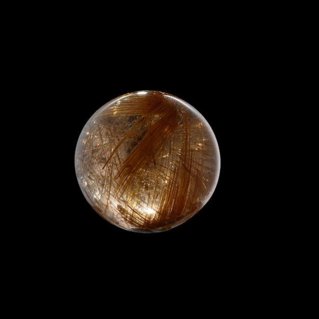 Ball of quartz with rutile on a black background