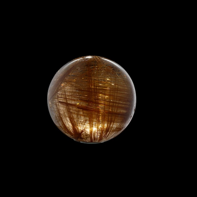 Ball of quartz with rutile on a black background