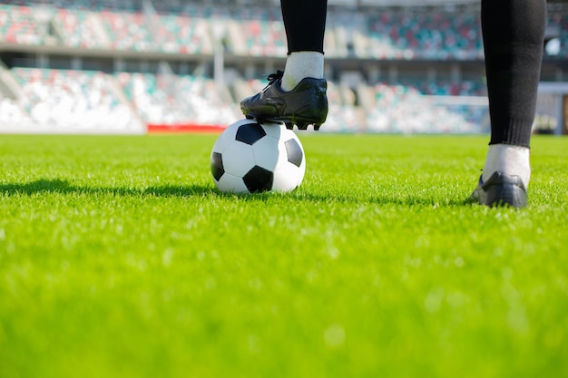 Ball with his feet on the football field