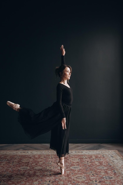 Ballet dancer on the black background