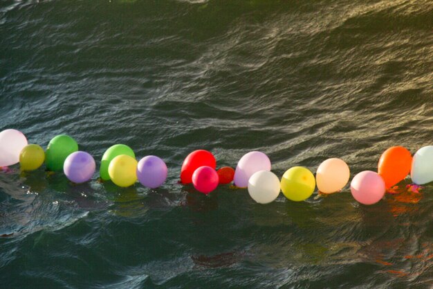 Balloon on a string for shooting game on water