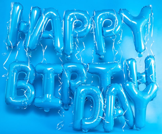 balloons letters happy birthday on blue background