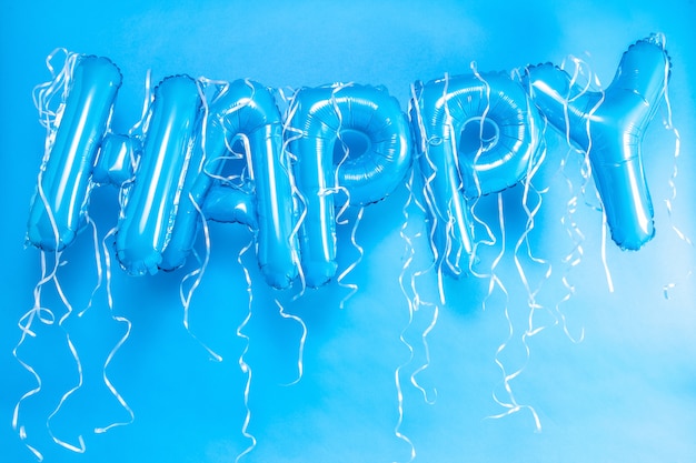 balloons letters happy on blue background