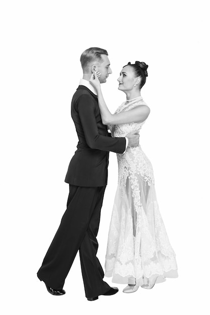 Ballrom dance couple in love holding hands isolated on white bachground