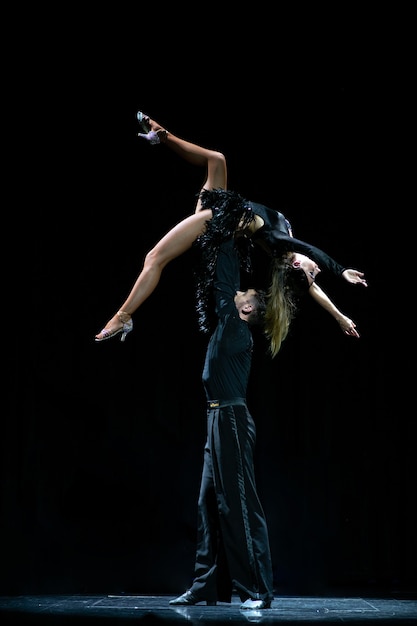 Ballroom couple dancing isolated on black.