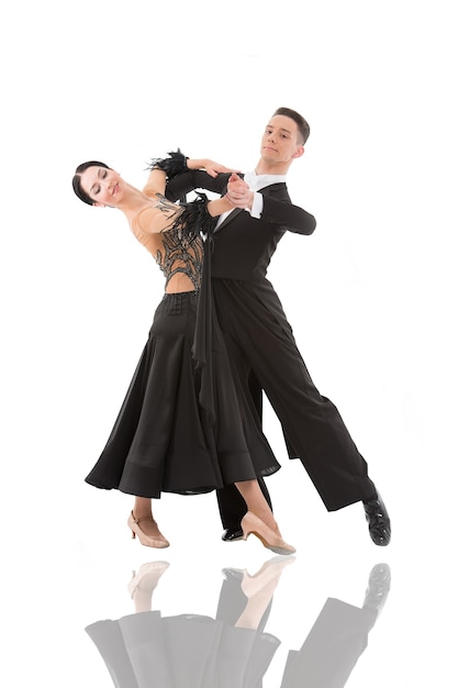 Ballroom dance couple in a dance pose isolated on white background. ballroom sensual proffessional dancers dancing walz, tango, slowfox and quickstep ballroom couple dance professional