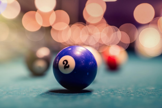 Balls for billiards stand in a triangle on a green table before the first serving of the ball