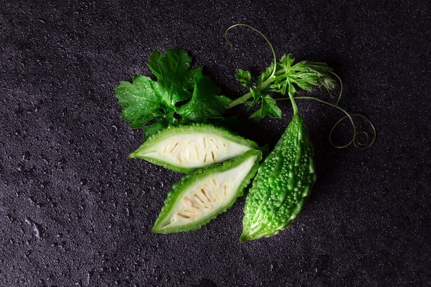 Balsam Pear on wet black stone plate background