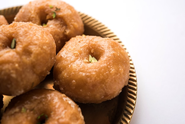 Balushahi sweet food served in a white or golden plate over moody background