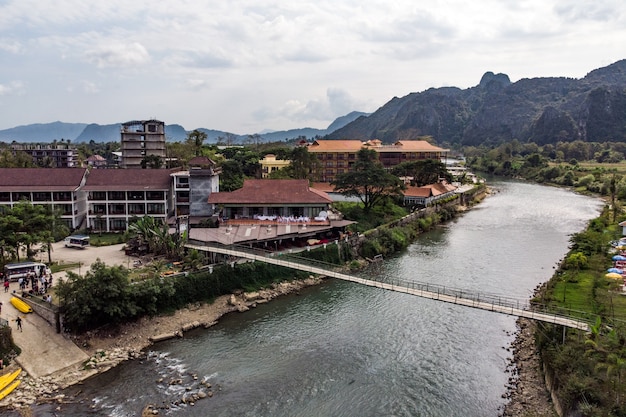 Bamboo bridge over Nam Song River at Vang Vieng village, Laos. Top view of the city. Urban landscape. Beautiful nature of Asia.