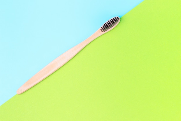 Bamboo brush on a blue and green background, copy space