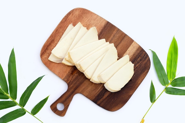 Bamboo shoots on wooden cutting board on white background