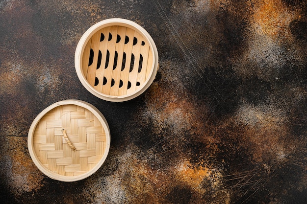 Bamboo steamer set, with copy space for text or food, with copy space for text or food, top view flat lay, on old dark rustic table background