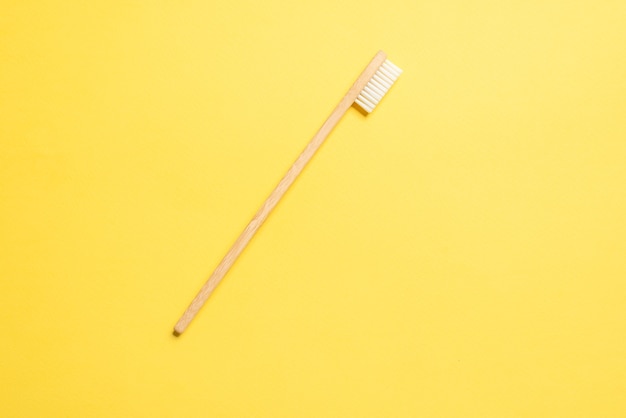 Bamboo toothbrush on a blue background. Top view.