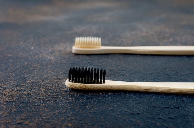 Bamboo toothbrush on dark concrete background