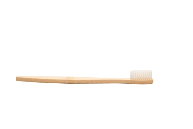 Bamboo toothbrush isolated on a white surface. Top view.