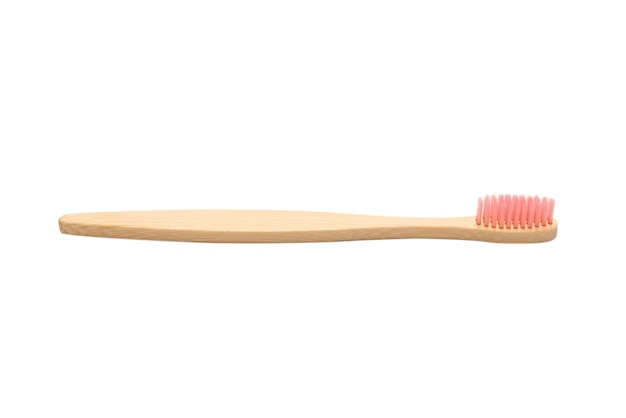 Bamboo toothbrush isolated on a white surface. Top view.