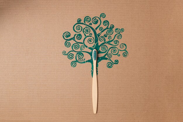 Photo bamboo toothbrush like tree trunk on cardboard creative concept, plastic free. high quality photo