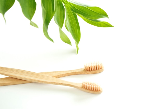 Bamboo toothbrushes are eco-friendly with a copy of the space on a white background. Zero waste. Free plastic. Top view.