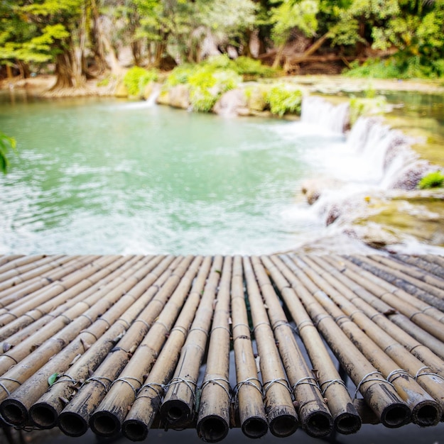 Bamboo wood bridge on blur waterfal nature background